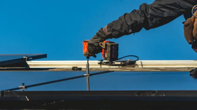 hand holsing screwdriver installing new solar panel