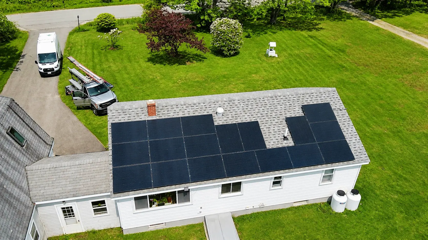small country house solar panels on top of light grey shingles