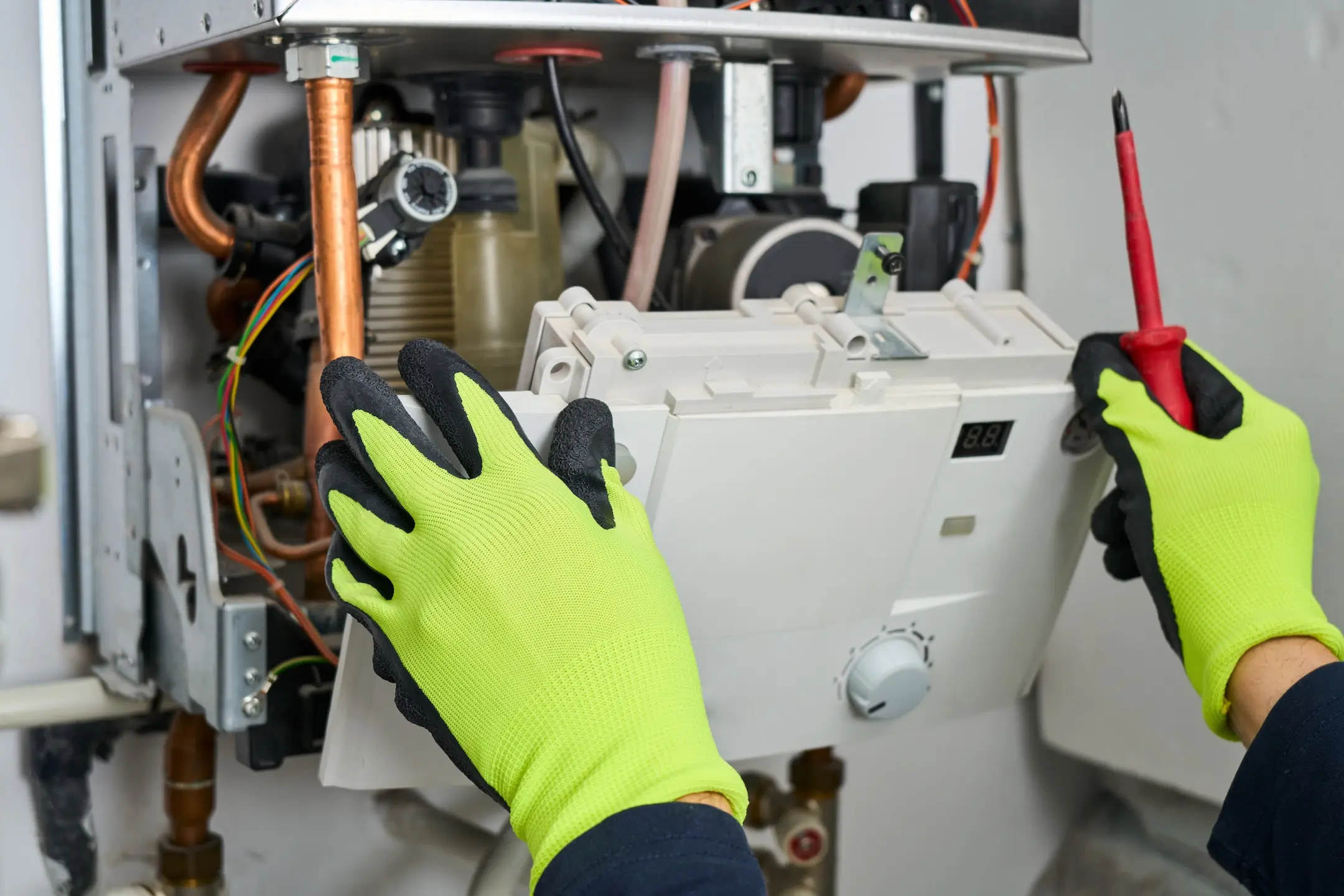 Technician repairing the boiler at home.