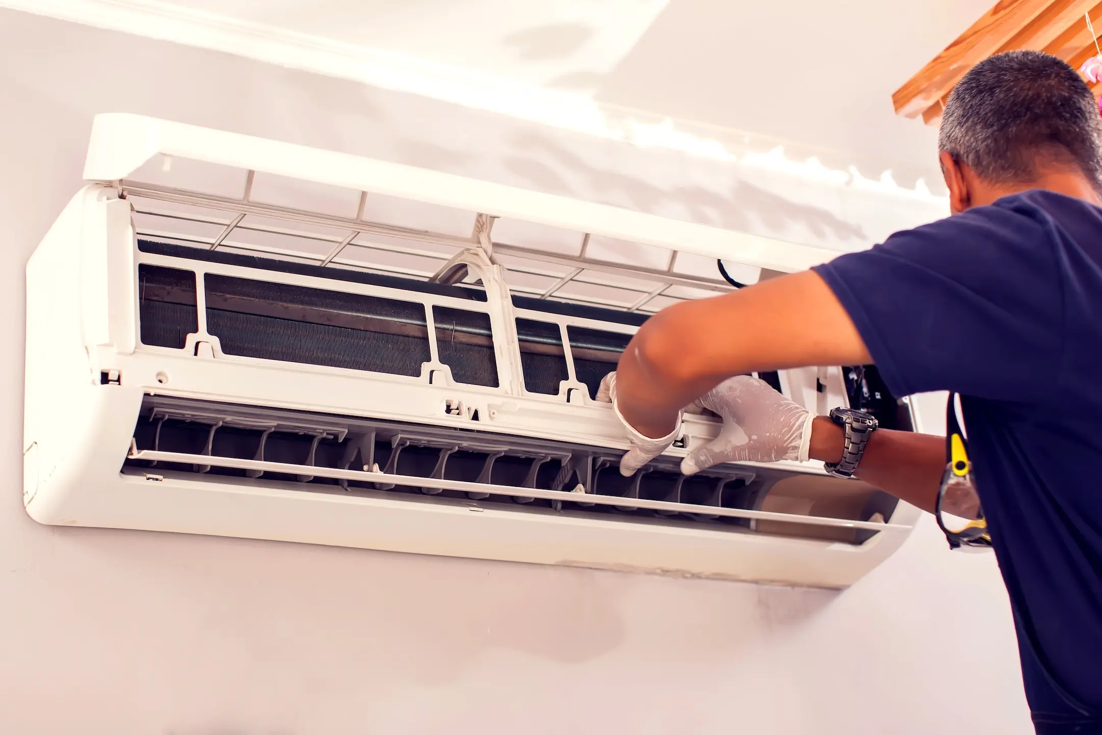 Man worker fixing air conditioning on the wall. Professional service