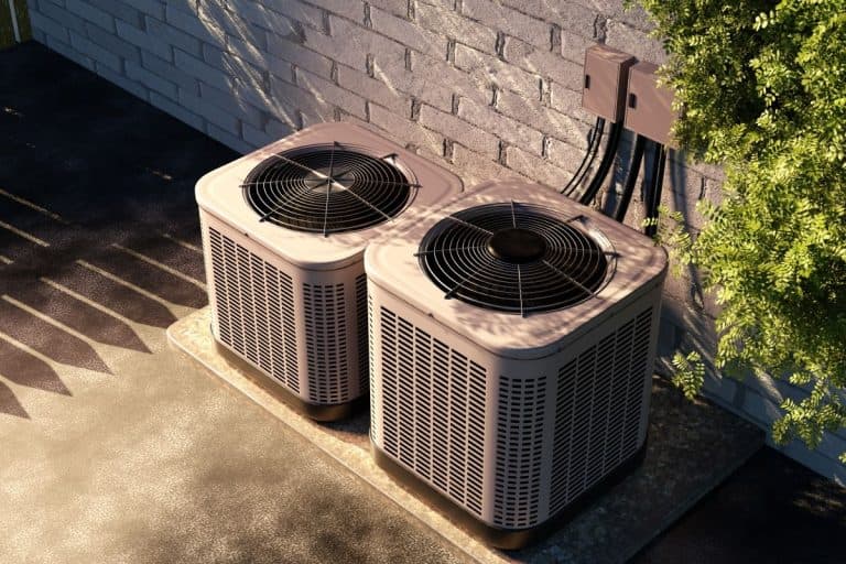 two-outdoor-air-conditioning-units-connected-to-a-brick-wall