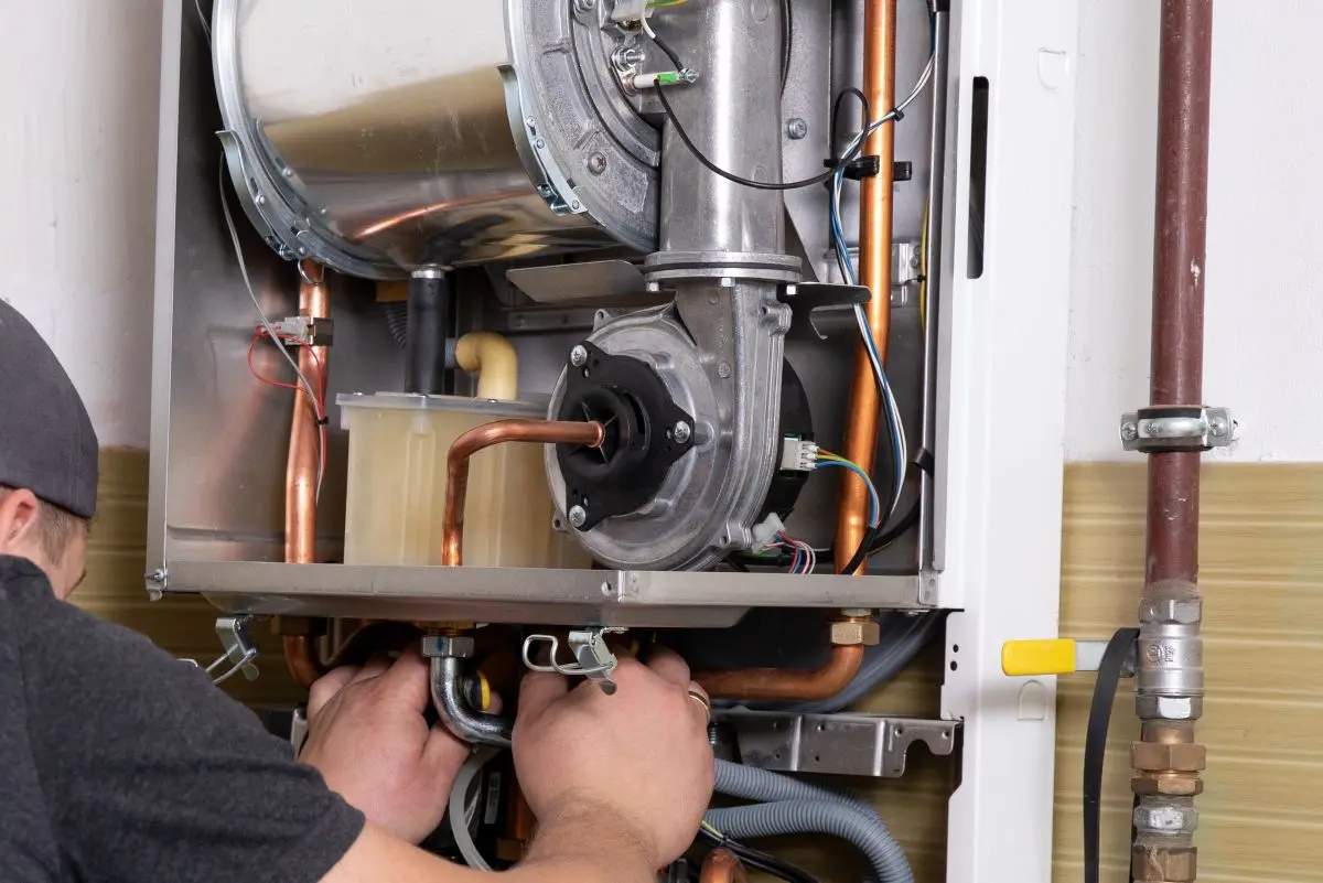 plumber-fixing-central-heating-system-Worker-servicing-a-gas-boiler