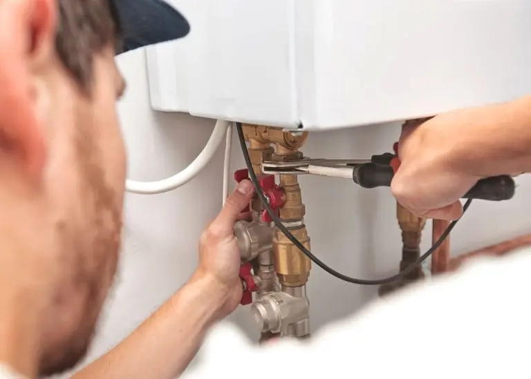 The-man-is-installing-the-heater-system-in-the-house-and-checking-pipes-by-the-wrench