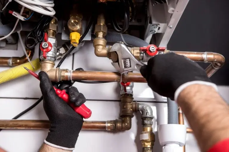 plumber-fixing-central-heating-system-