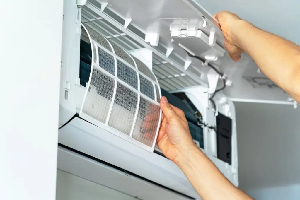 Repairmans-hands-changes-cleaning-filter-in-air-conditioner.-Air-conditioning-maintenance