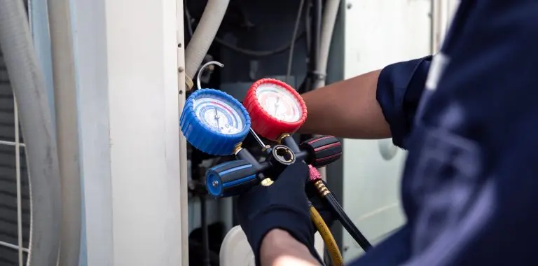Air conditioning, HVAC service technician using gauges to check refrigerant and add refrigerant,Air Conditioning Repair, repairman on the floor fixing air conditioning system.