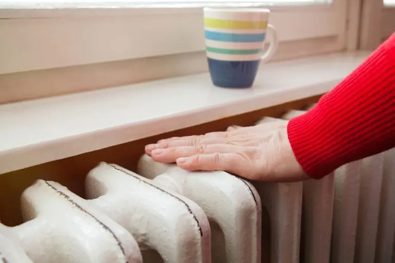 A hand touching the radiator