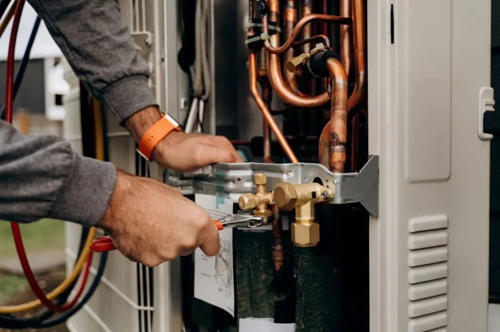 Technicians-hands-with-tools-working-on-the-copper-pipes-of-the-air-conditioner