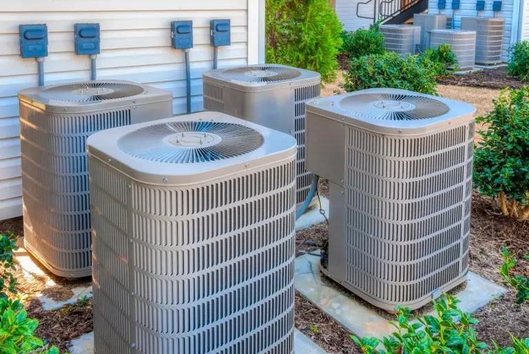 Horizontal shot of four air conditioning units outside