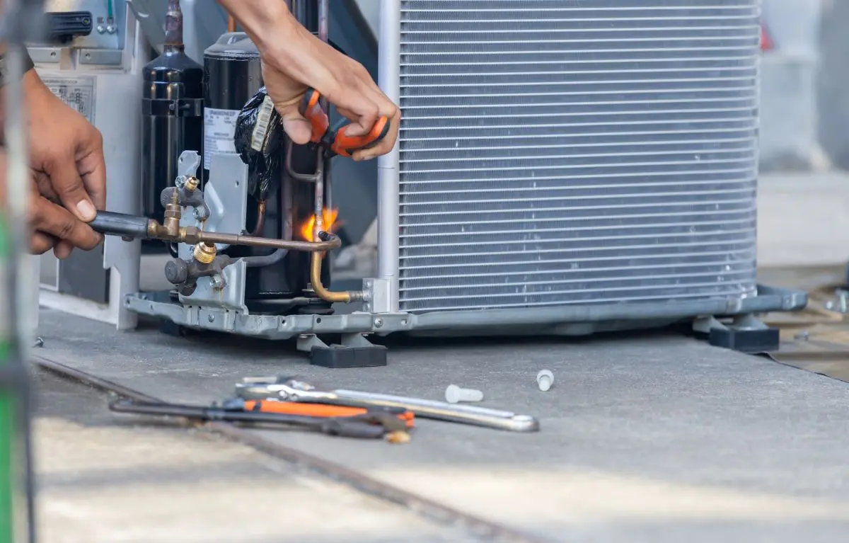 Close up of Air Conditioning Repair team use fuel gases and oxygen to weld or cut metals