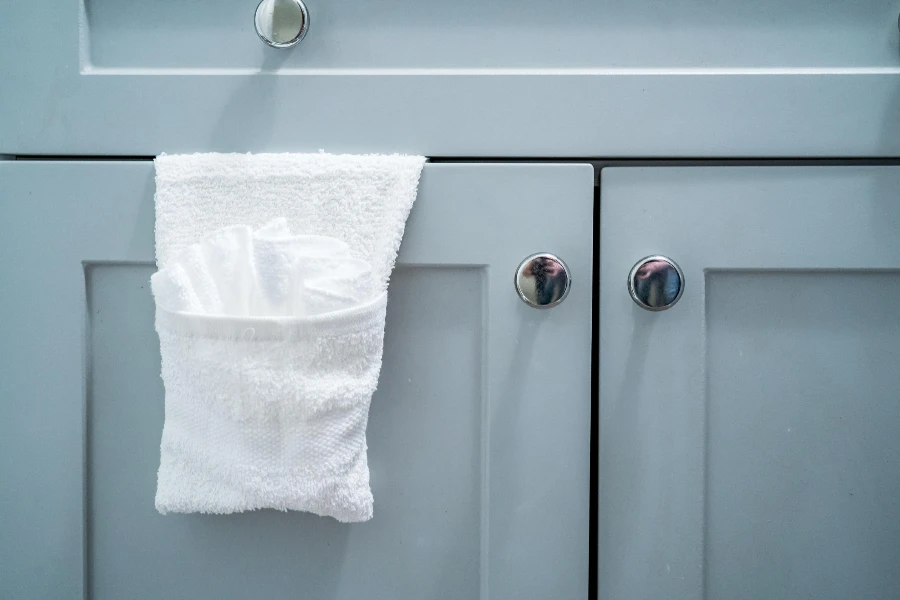 close up of bathroom storage cabinet with white towel