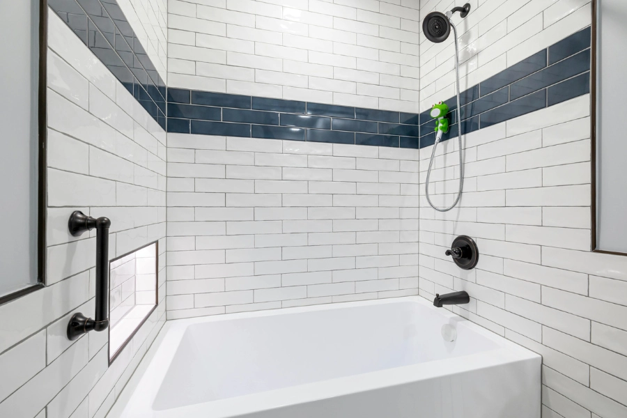 Bathroom with white and blue subway tiles.