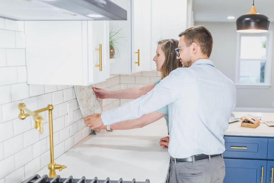 homeowners comparing backsplash tile samples during a kitchen remodeling project