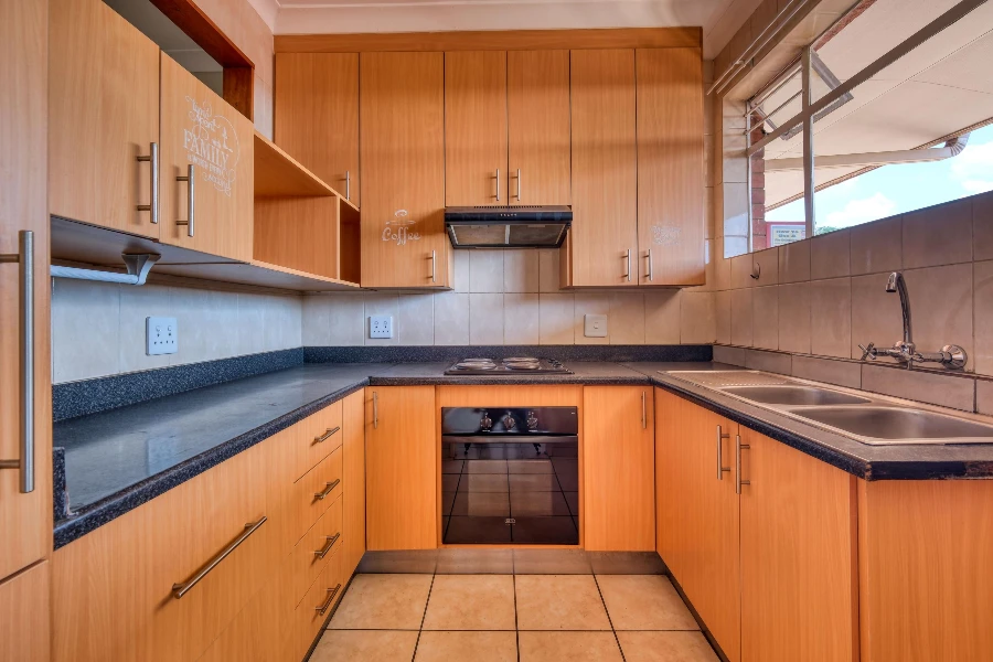 modern kitchen with natural wood cabinets and sleek countertops