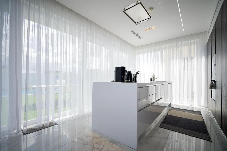 modern kitchen with sheer curtains and natural light