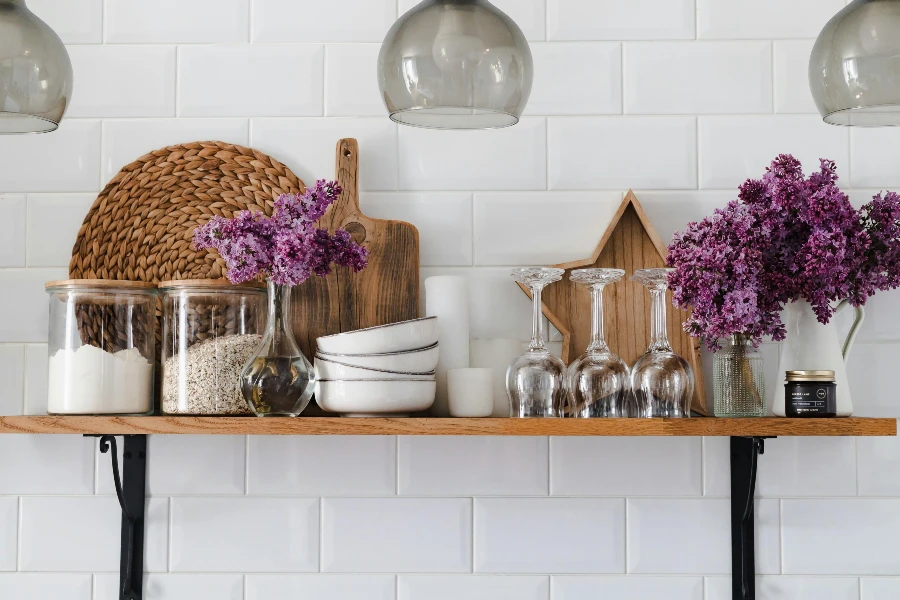 open kitchen shelf decorated with plants, dishes, and practical kitchen accessories