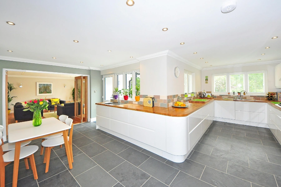 A spacious modern kitchen with elegant interiors featuring tile flooring.