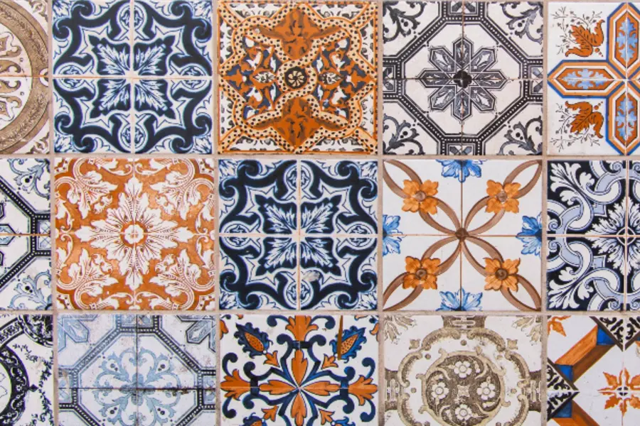 a close up of a tiled wall with different designs