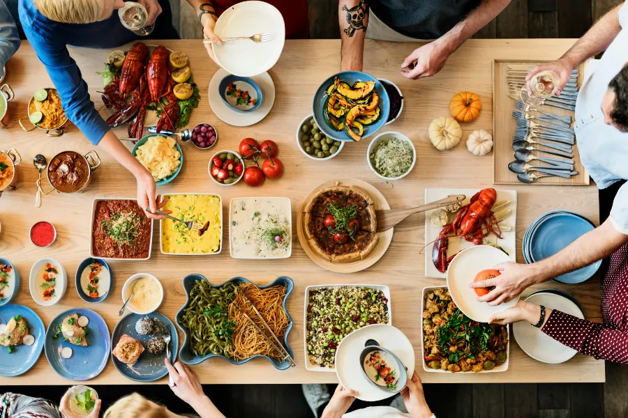 top view of people dishing food from table