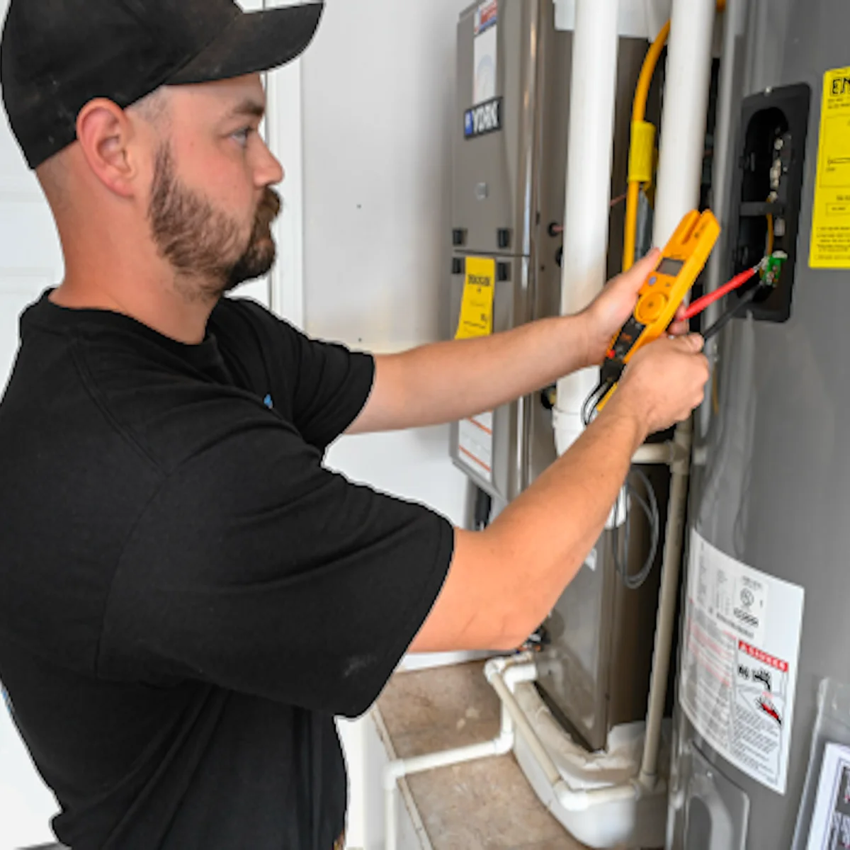 Division One Plumbing service tech diagnosing water heater