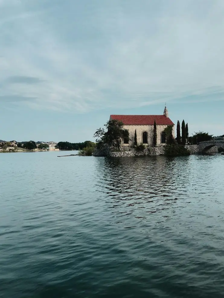 Tranquil scene of the Bella Donna Chapel reflecting in the reservoir at McKinney, Texas.