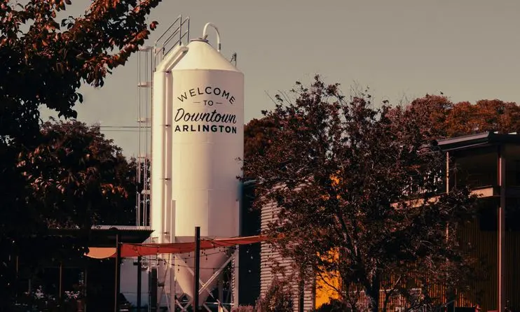 Industrial scene in Arlington, Texas featuring a prominent silo and surrounding autumn foliage.