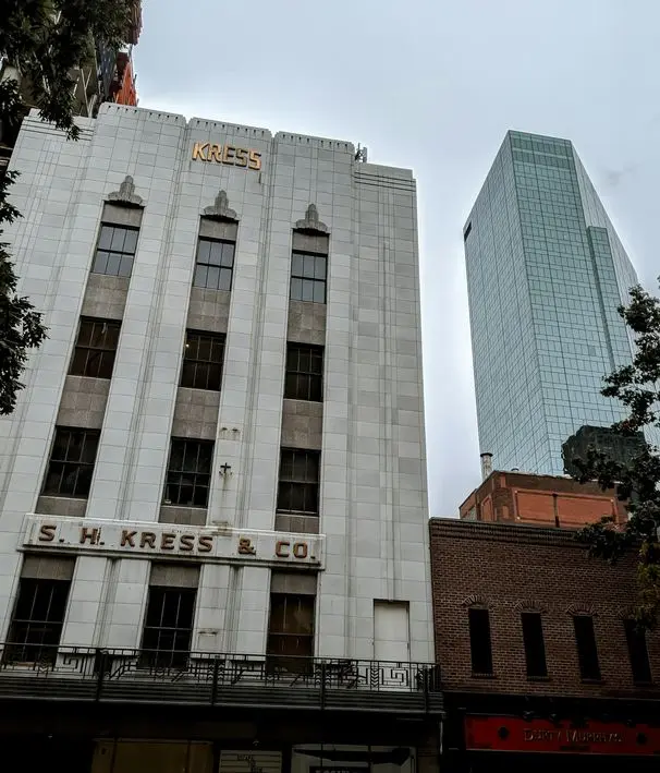 Urban landscape of downtown Fort Worth with the historic Kress building and modern skyscrapers.