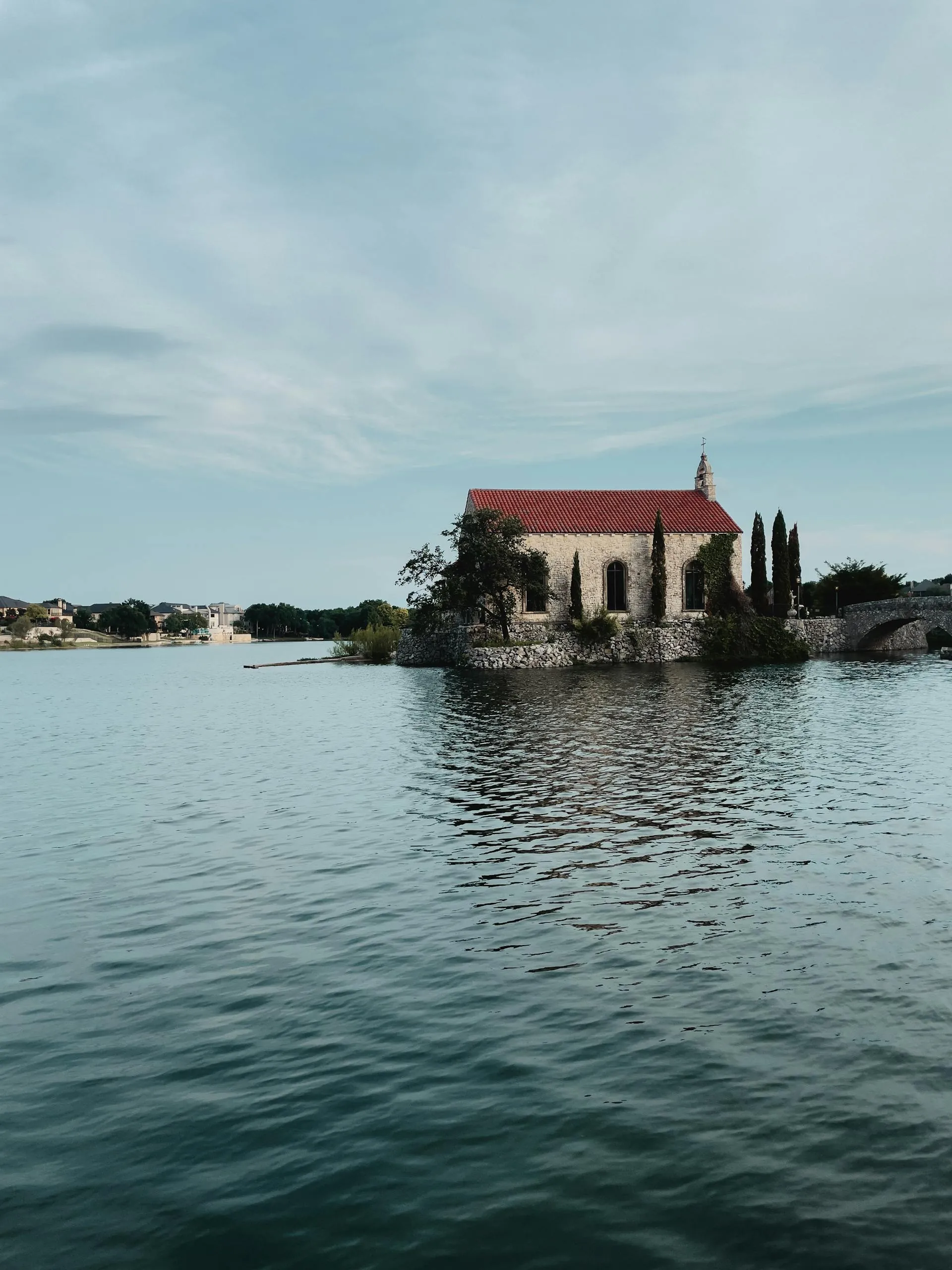 Tranquil scene of the Bella Donna Chapel reflecting in the reservoir at McKinney, Texas.