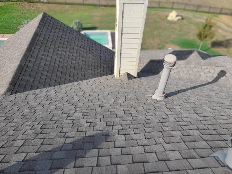 Asphalt shingle roof replacement with new chimney flashing detail