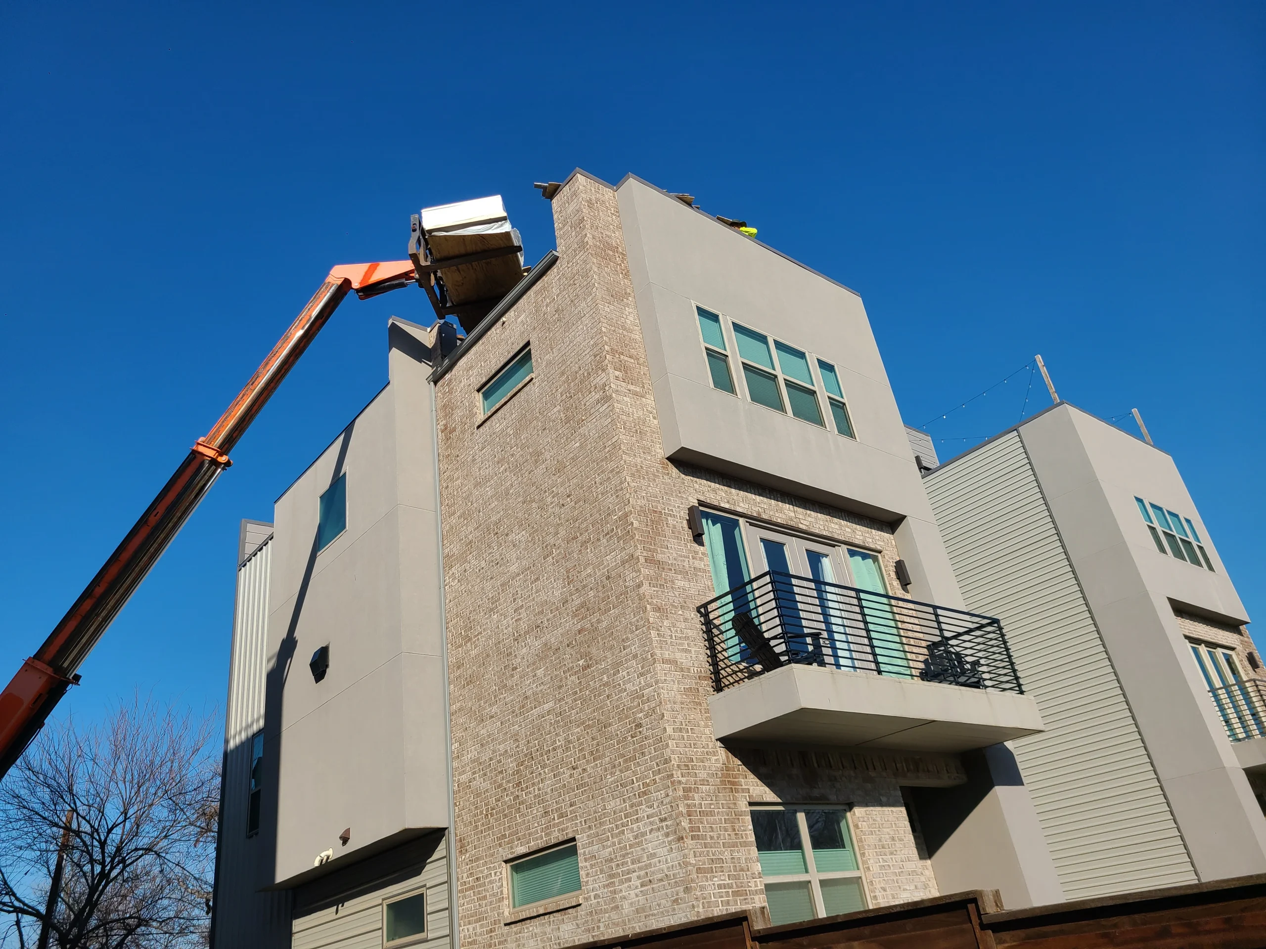 Boom lift providing roof access on a Fort Worth commercial job