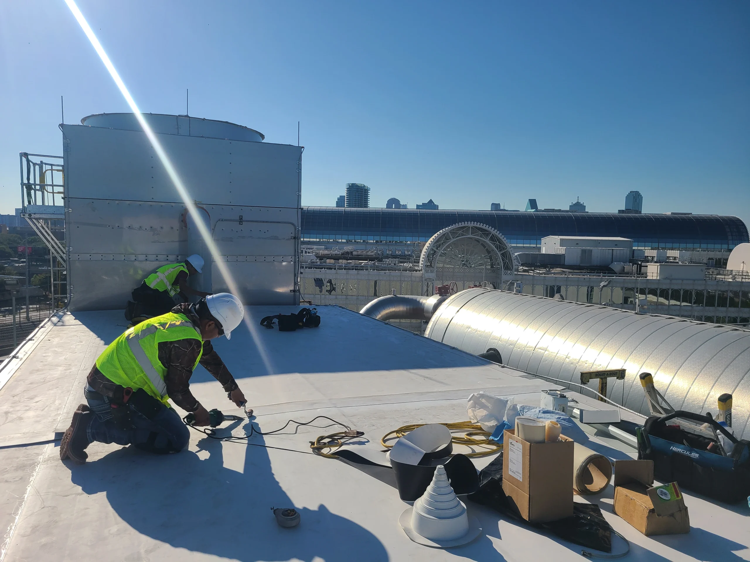 Commercial roof coating applied around rooftop ductwork