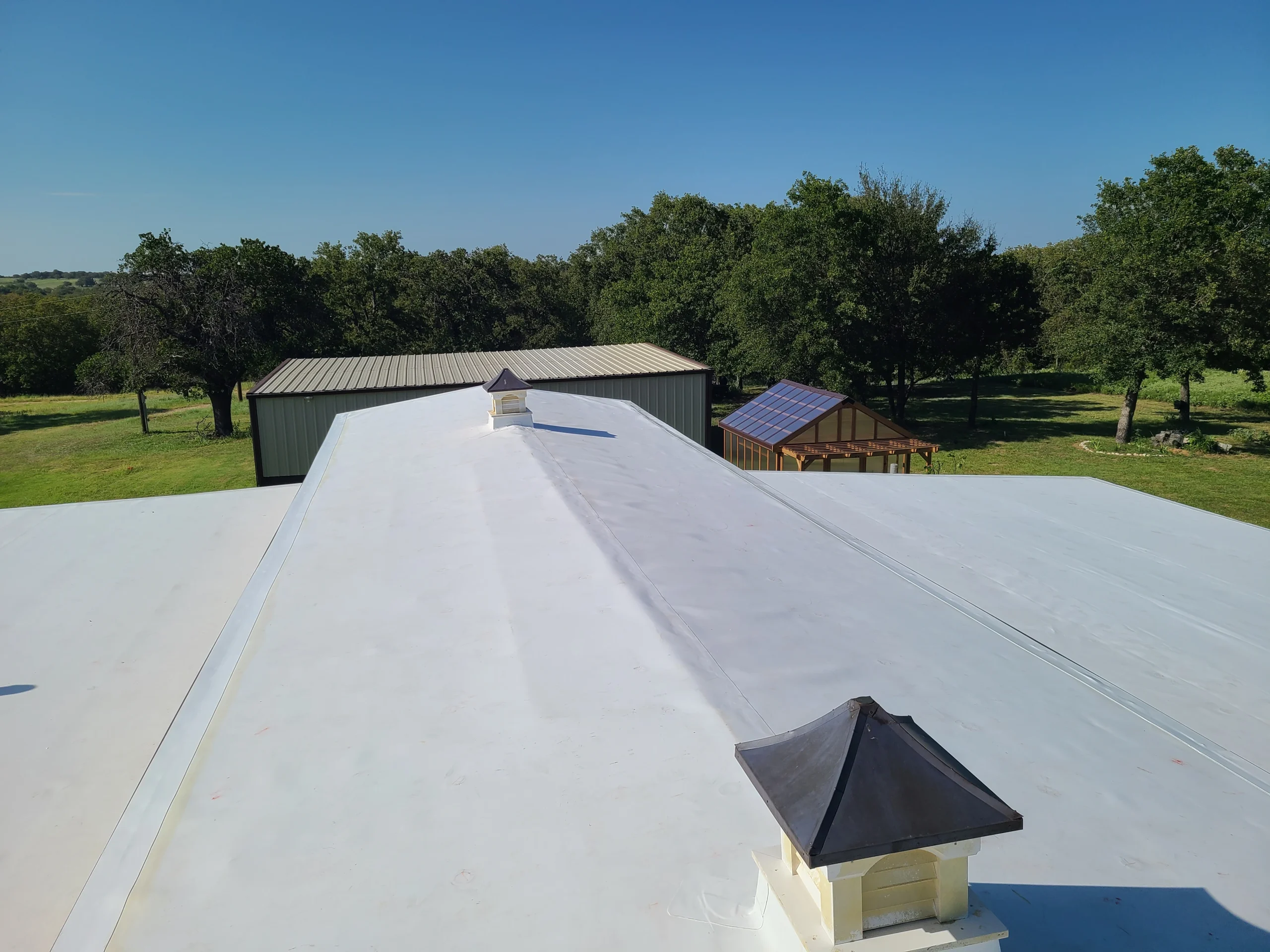 Completed TPO flat roof on a brick commercial building
