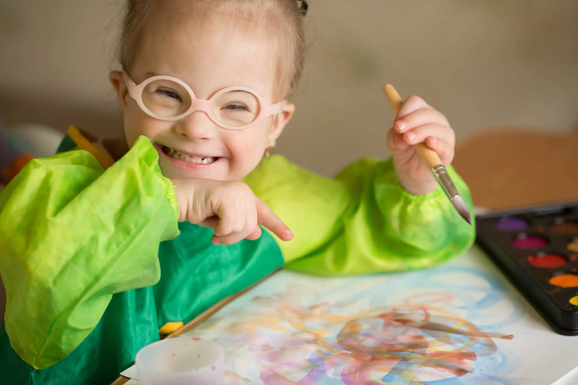 A Girl Showing Her Artwork in Ivy Lane Pediatrics in Utah