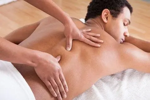 Person receiving a relaxing back massage therapy.