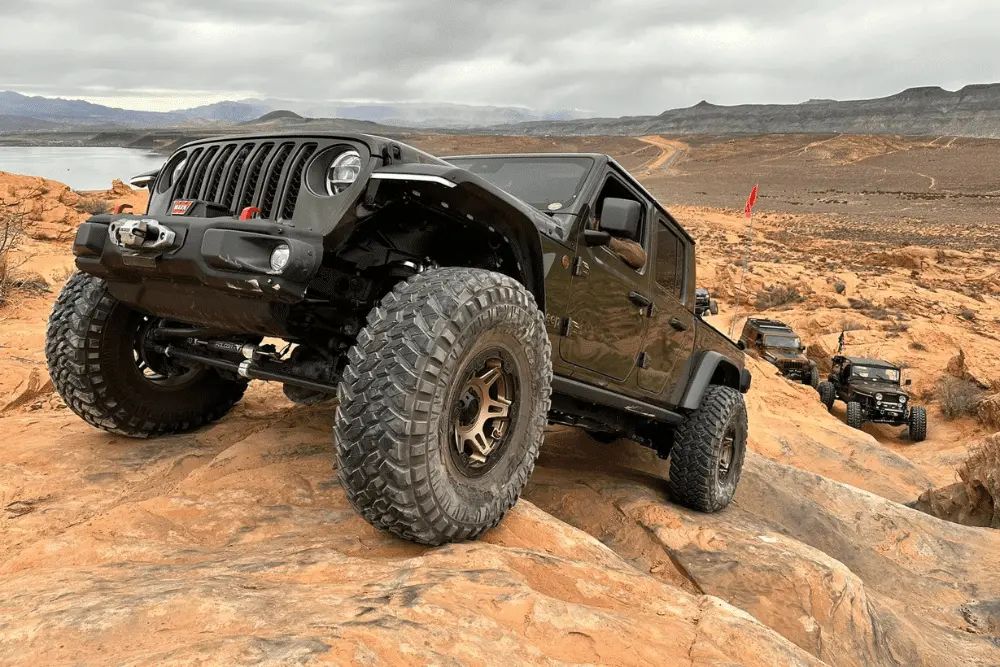 4x4 regearing in Grand Junction, CO by Barney Brothers Off-Road & Repair. Image of a lifted Jeep Wrangler tackling rocky terrain, showcasing the shop’s commitment to performance, durability, and adventure-ready upgrades.