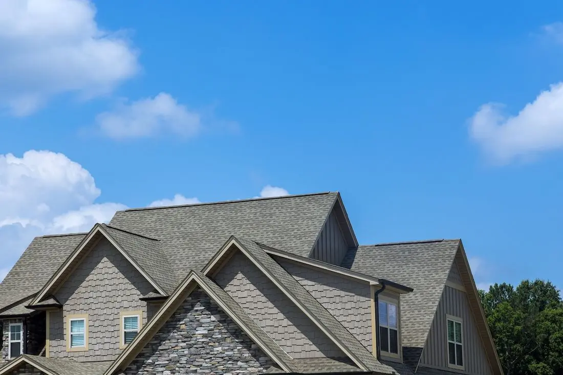 Work on a new roof covering asphalt shingles in the roofing construction of a house