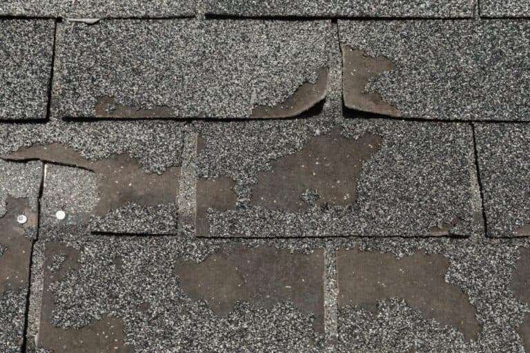 Broken worn asphalt roofing shingles