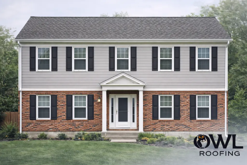 80's neo colonial home with light gray siding and a darker roof for our brick and siding combinations blog