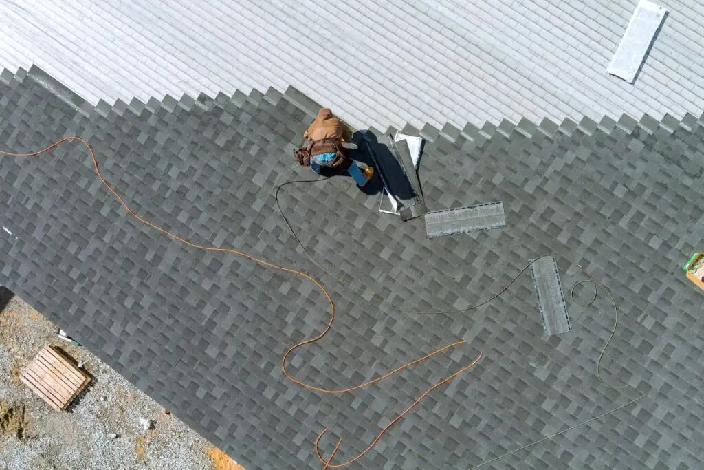 roofer installing shingles on a roof