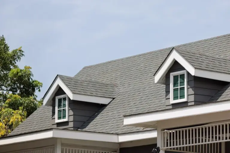 Roofing Stillwater Roof shingles with garret house on top of the house. dark asphalt tiles on the roof background on afternoon time. dark asphalt tiles on the roof background