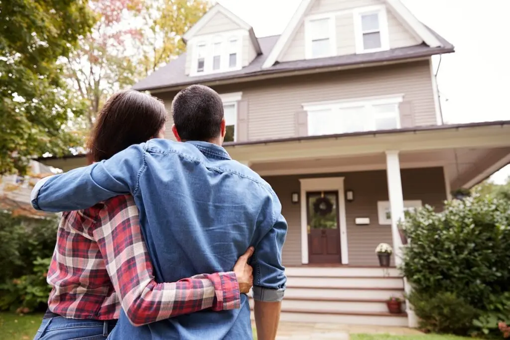 Rear View Of Couple Looking At House