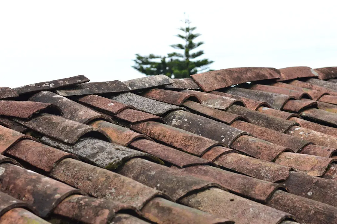 Close-up of brown asphalt roof shingles on a residential home during replacement