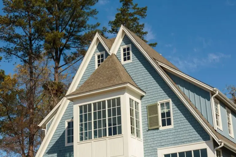 Roofing Saint Paul Double-peaked roof of blue family home