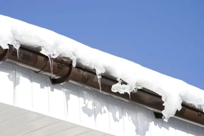 Roof and gutters covered in snow