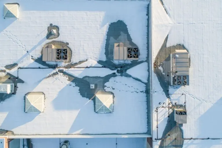 aerial view of a flat commercial roof covered in snow