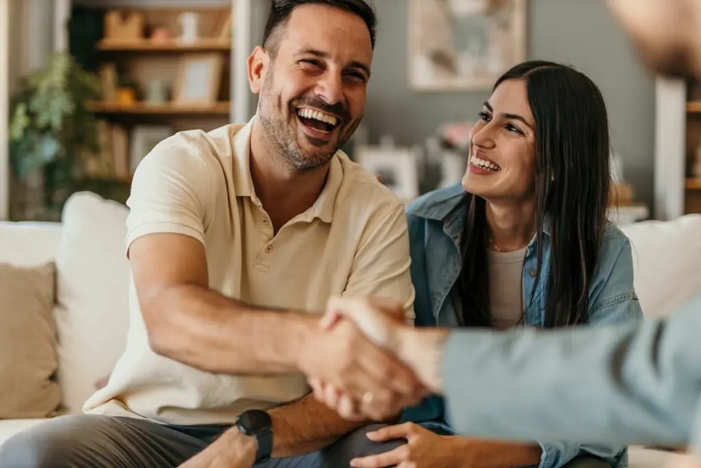 couple shakes hands with contractor