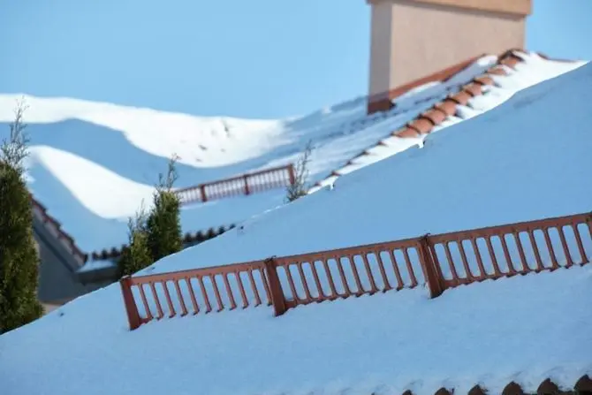 Snow guard for safety in winter on house roof top covered with steel shingles
