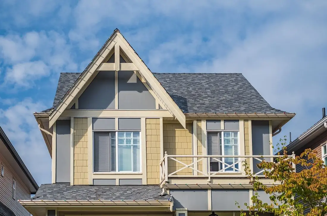 A perfect neighborhood. Houses in suburb in the north America. Top of a luxury house with nice windows over blue sky. Beautiful Home Exterior. Real Estate Exterior Front House