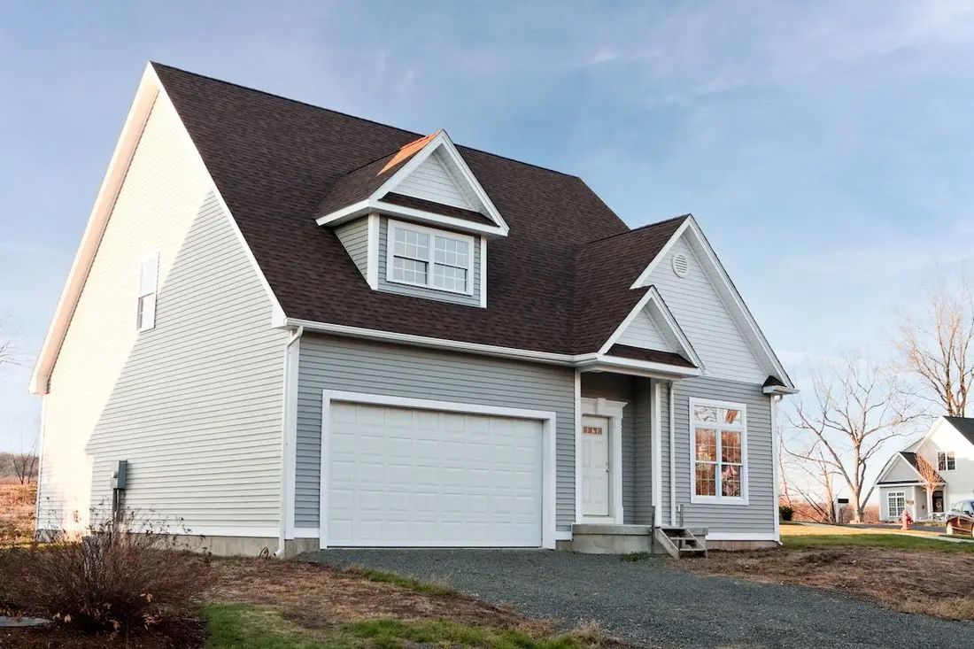 Modern custom built house newly constructed with a two car garage in a residential neighborhood.