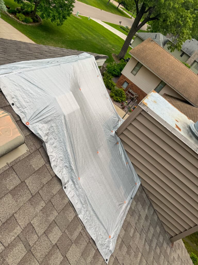 Tarp covering roof for leak in Shoreview Minnesota, where a roof leak repair was then carried out